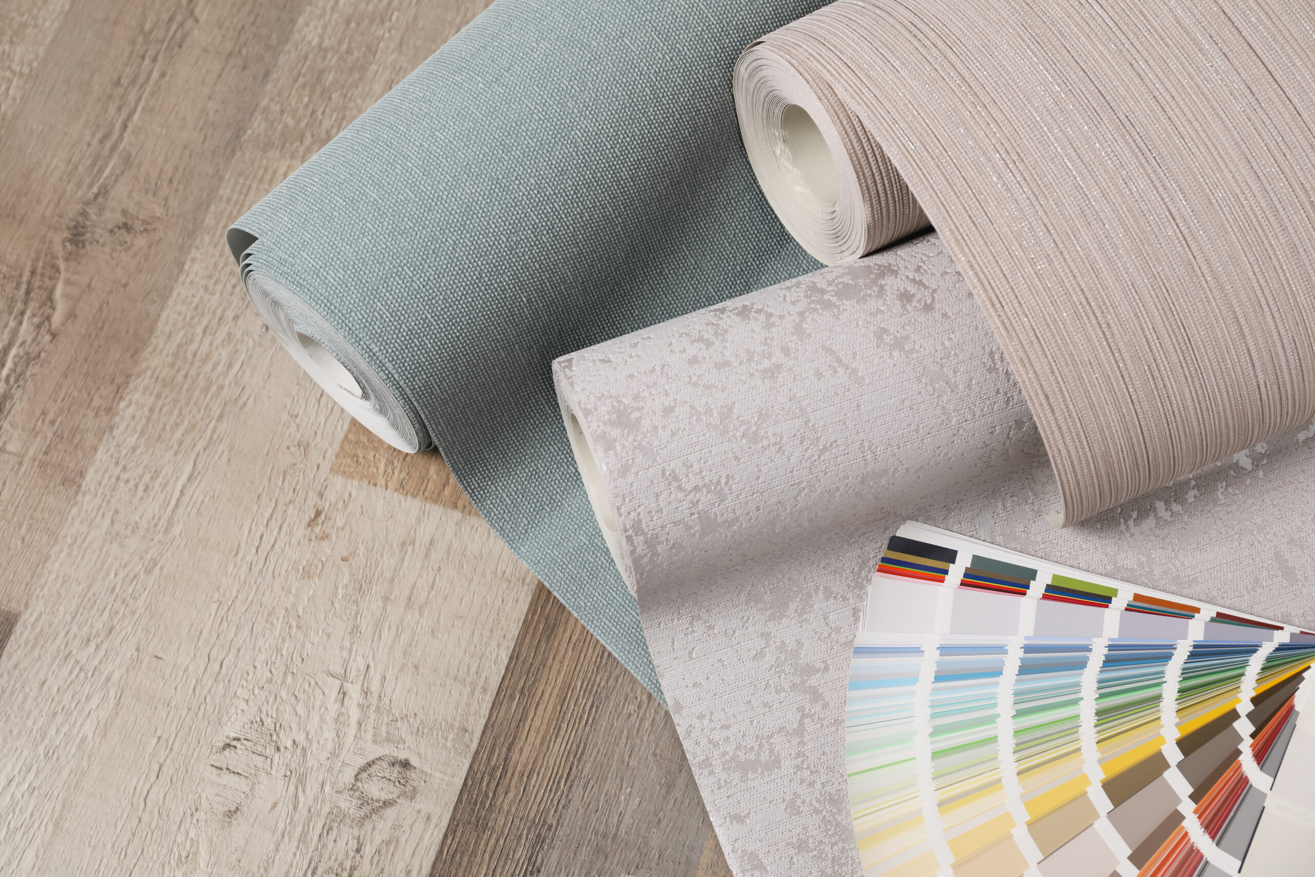 wall paper rolls and color palette on wooden floor