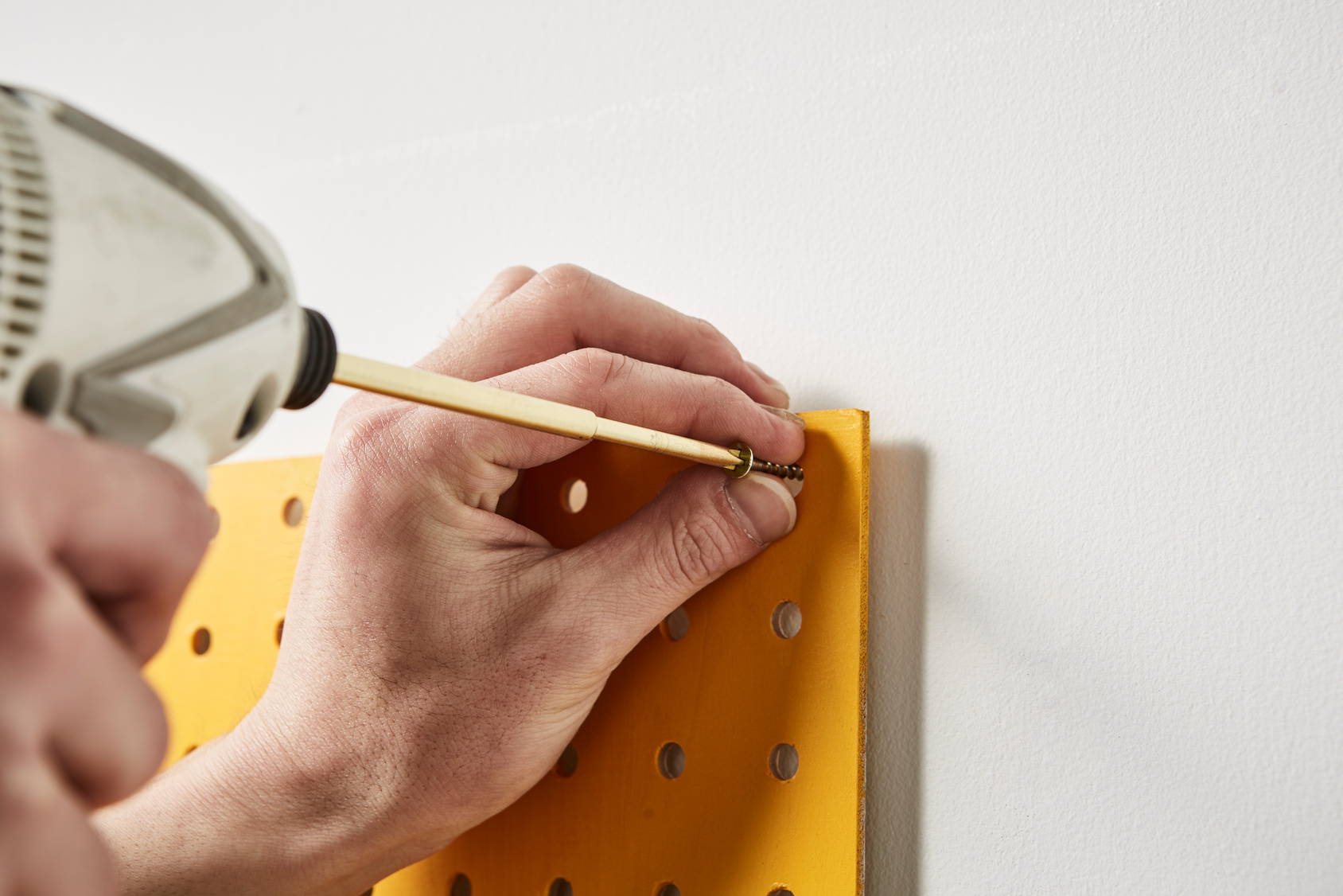 パネルを壁に取り付ける男性